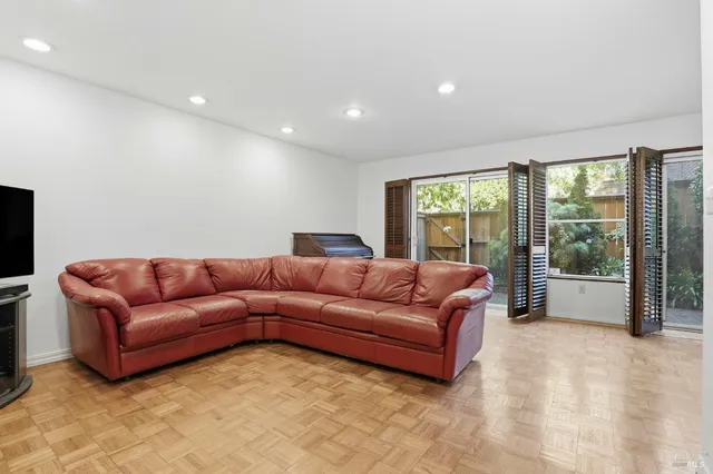 a living room with furniture and large windows