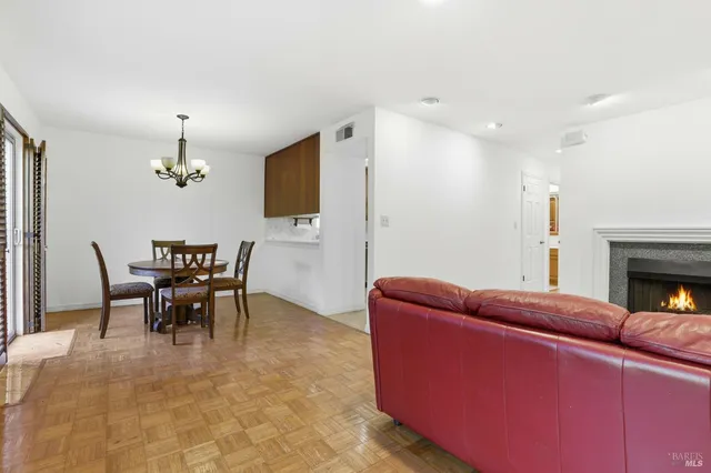 a living room with furniture a dining table and a fireplace