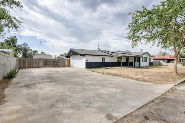 a front view of house with a garden