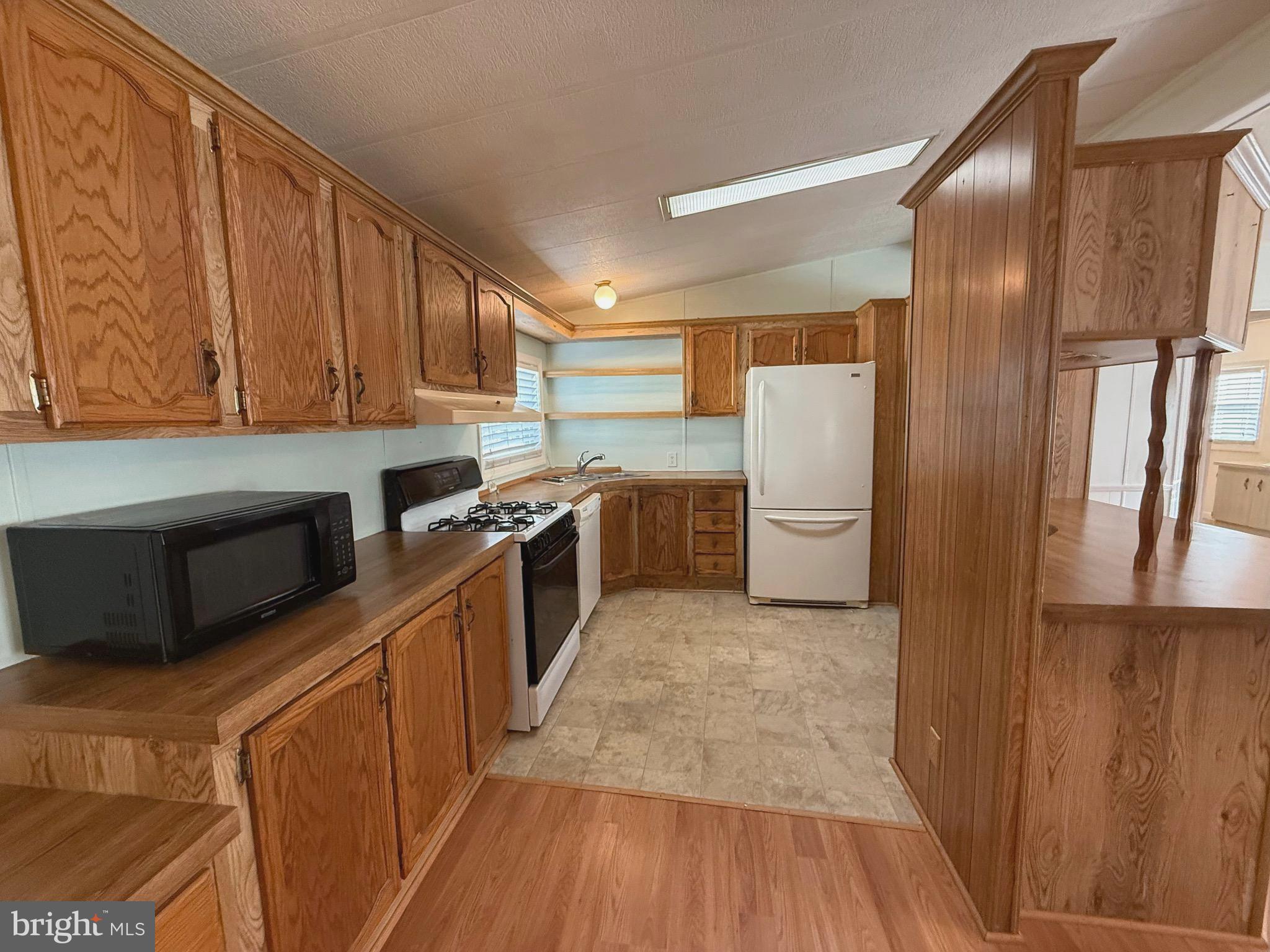 386 Indian Way Buena, NJ 08310 - Photo 5 of 53 a kitchen with stainless steel appliances granite countertop a refrigerator a stove a sink and a microwave