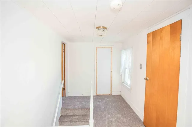 a view of a hallway with a bathroom
