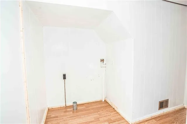 a view of a room with wooden floor