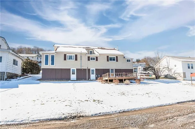 a view of a house with snow on the road