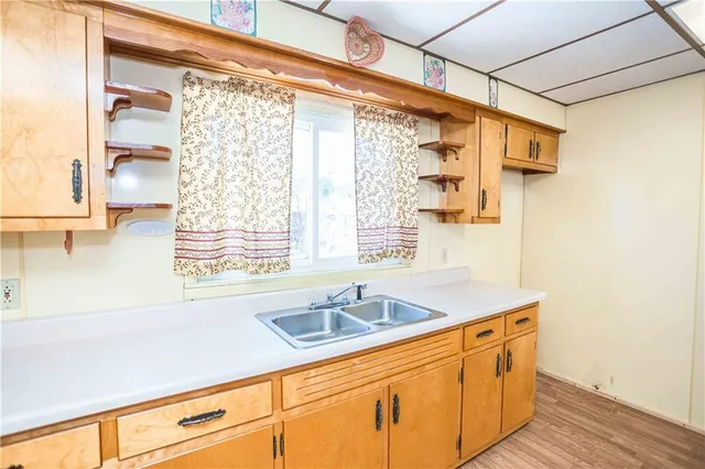 a kitchen with stainless steel appliances a sink and a window