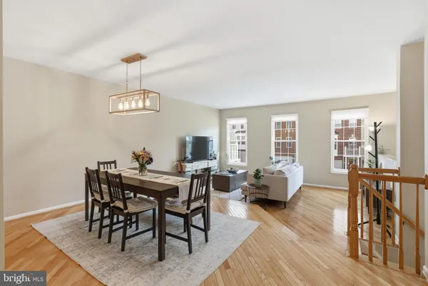 an empty room with windows fireplace and wooden floor