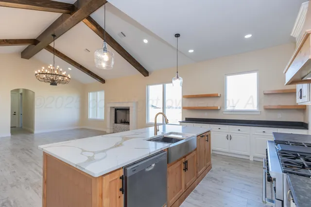 a kitchen with a stove a sink and a refrigerator