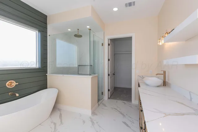 a bathroom with a granite countertop sink a toilet and bathtub