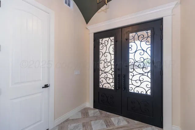 an empty room with windows and entryway