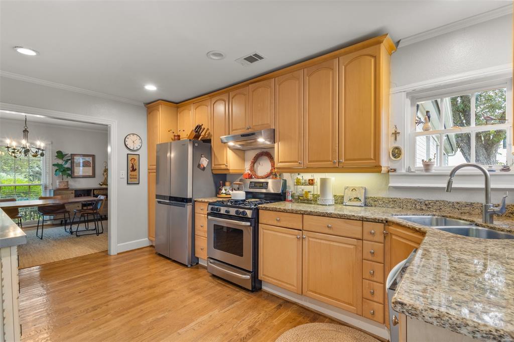 9461 Waterview Road Dallas, TX 75218 - Photo 13 of 40 a kitchen with stainless steel appliances granite countertop a stove a sink dishwasher and a refrigerator