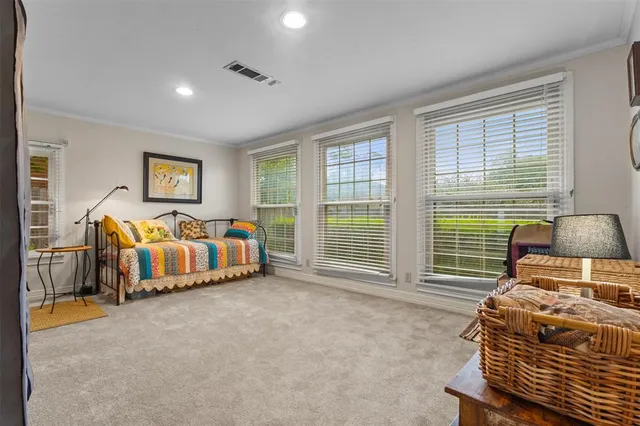 a bedroom with double bed and a large window