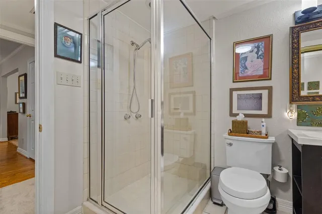 a bathroom with a toilet a sink and shower