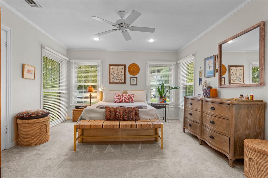 9461 Waterview Road Dallas, TX 75218 - Photo 20 of 40 a bedroom with a bed and a chandelier