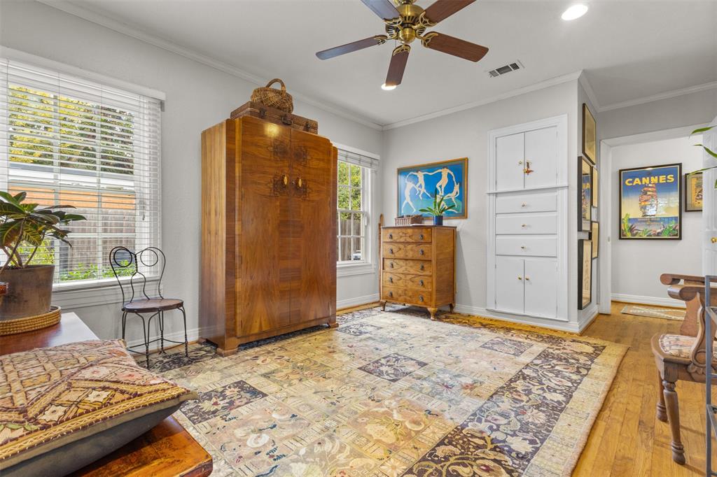 9461 Waterview Road Dallas, TX 75218 - Photo 25 of 40 a bedroom with a bed and a chandelier