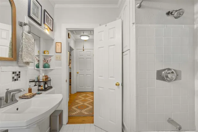 a bathroom with a granite countertop shower sink and mirror