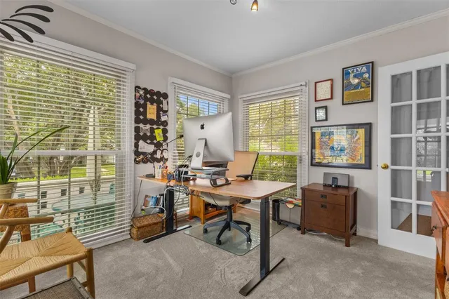 a view of a workspace with furniture and a window