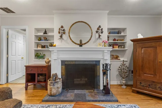 a living room with a fireplace a rug and a window