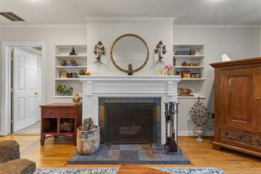 9461 Waterview Road Dallas, TX 75218 - Photo 8 of 40 a living room with a fireplace a rug and a window