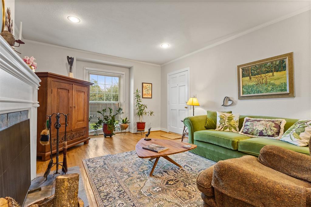 9461 Waterview Road Dallas, TX 75218 - Photo 9 of 40 a living room with furniture a fireplace and a table