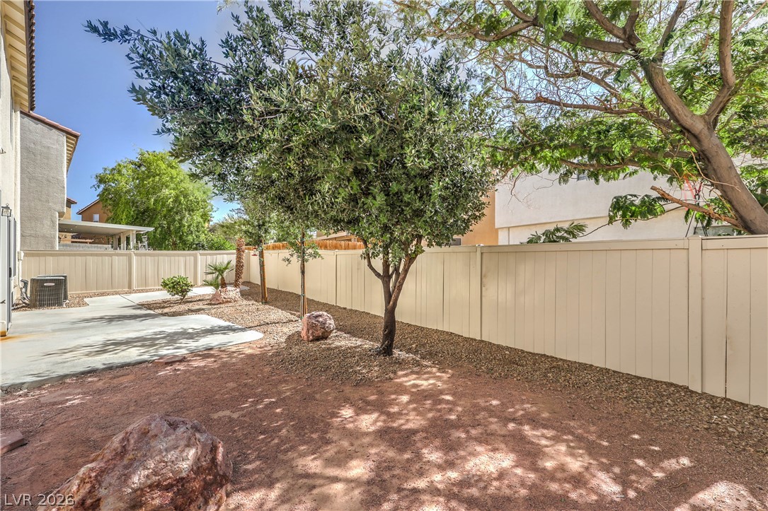 10939 Paradise Road Henderson, NV 89052 - Photo 33 of 36 A spacious backyard awaits, featuring a durable fence and ample room for outdoor activities.
