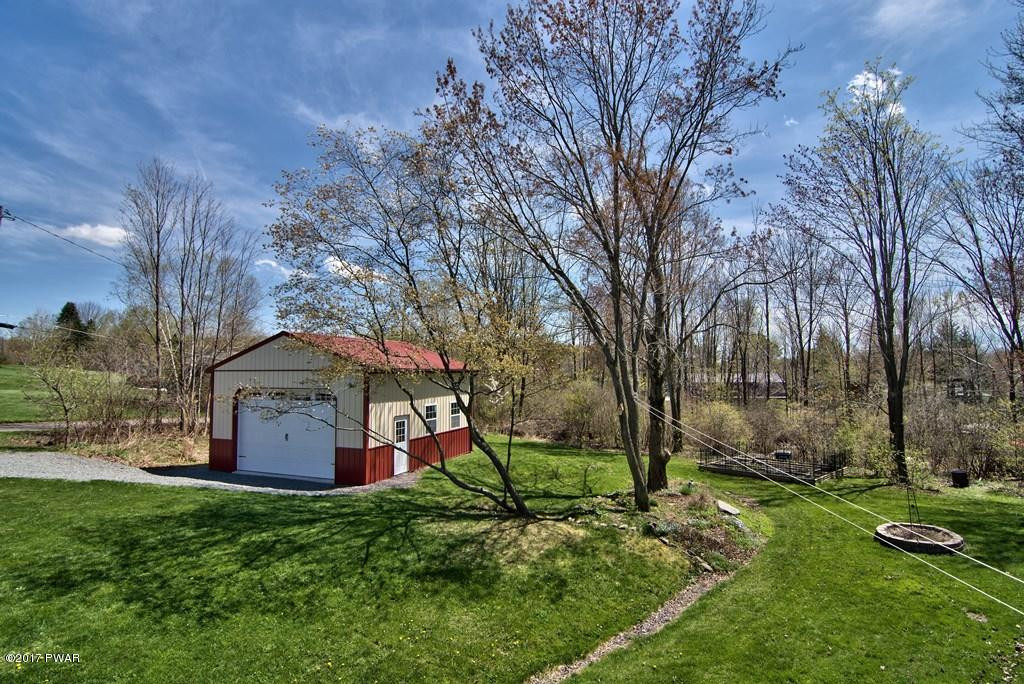 1058 Rosengrant Road Lake Ariel, PA 18436 - Photo 31 of 47 a backyard of a house with lots of green space