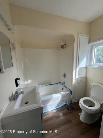 a bathroom with a sink a toilet and a mirror