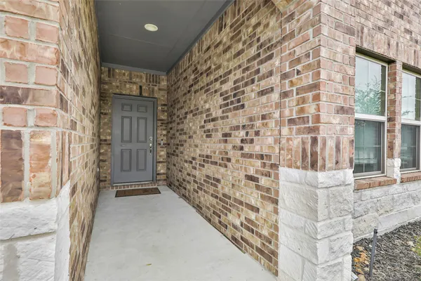 a view of front door of house with stairs