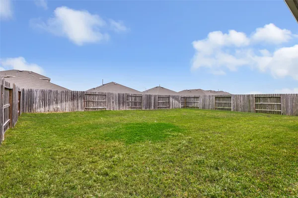 a view of a house with a big yard and large trees