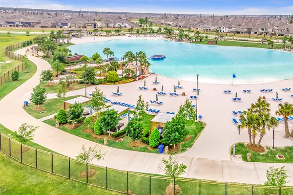an aerial view of residential houses with outdoor space and swimming pool