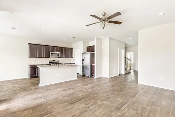 a view of kitchen with refrigerator and microwave