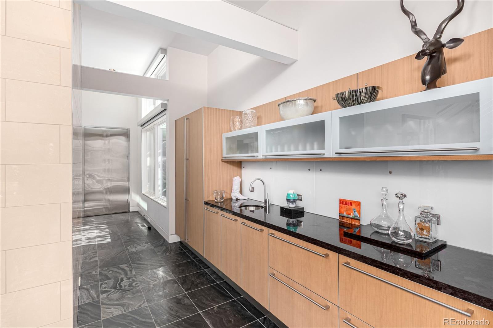 301 Monroe Street Denver, CO 80206 - Photo 15 of 44 a kitchen with stainless steel appliances a cabinets and a counter top space