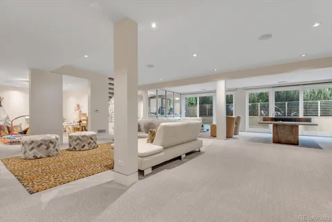 a bedroom with furniture and large window