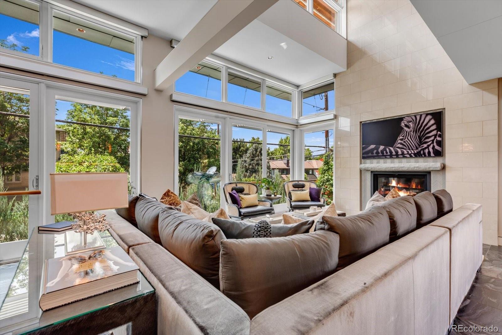 301 Monroe Street Denver, CO 80206 - Photo 9 of 44 a living room with furniture and a large window