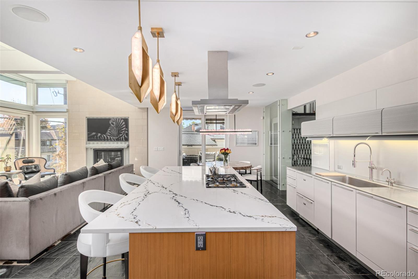 301 Monroe Street Denver, CO 80206 - Photo 10 of 44 a room with stainless steel appliances kitchen island granite countertop a sink and cabinets