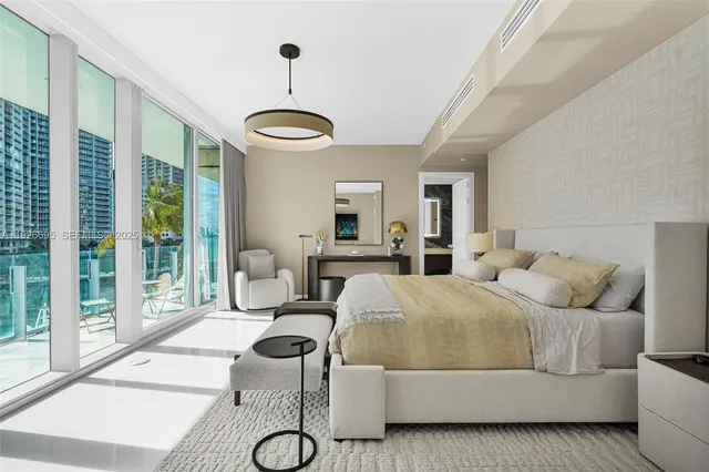a bathroom with a tub and view of living room
