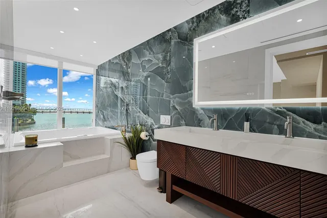 a bedroom with a large bed and a flat screen tv