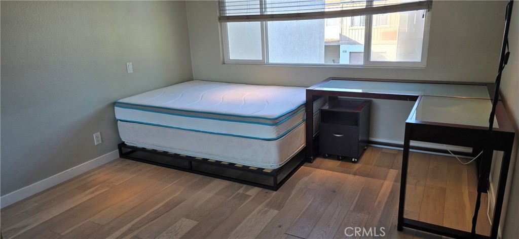 5224 Walnut Avenue, Unit 8 Irvine, CA 92618 - Photo 13 of 14 a room with a bed and a window