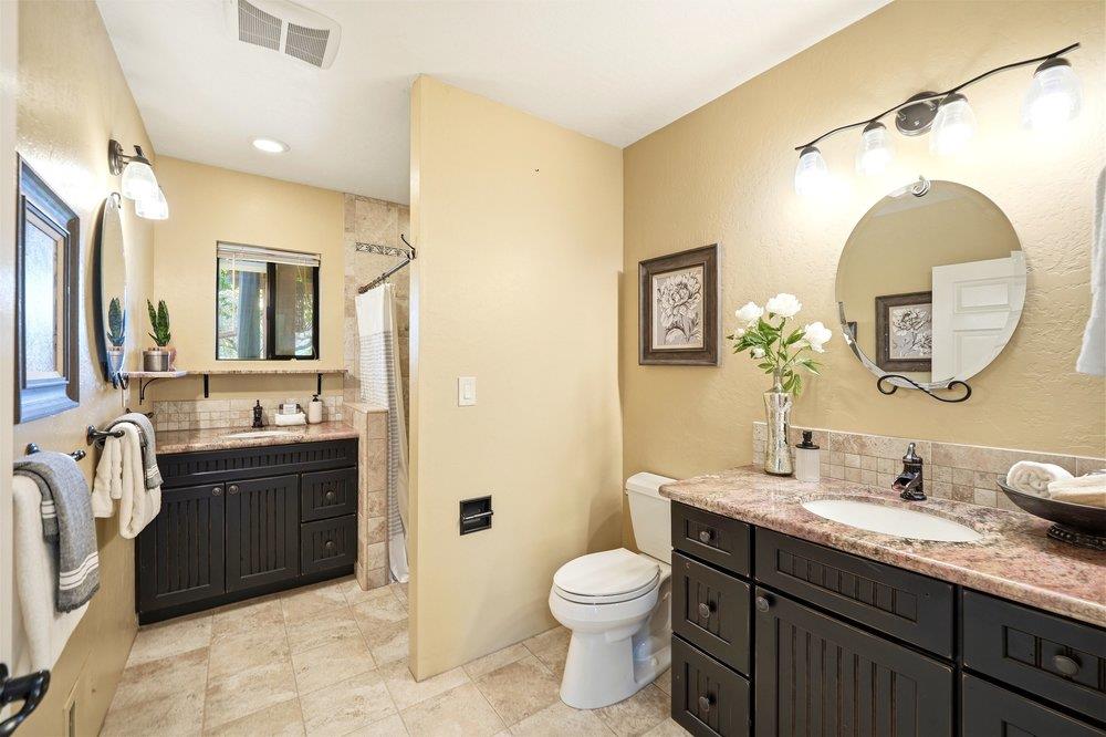 17235 Hill Road Morgan Hill, CA 95037 - Photo 14 of 44 a spacious bathroom with a double vanity sink a mirror a bathtub and a shower