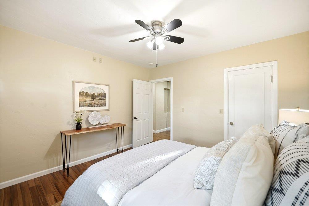 17235 Hill Road Morgan Hill, CA 95037 - Photo 16 of 44 a bedroom with a large bed and a chandelier