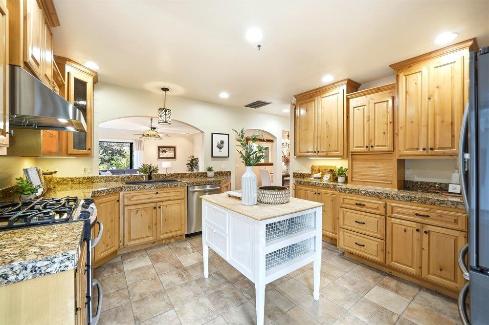 17235 Hill Road Morgan Hill, CA 95037 - Photo 5 of 44 a kitchen with stainless steel appliances granite countertop a stove top oven a sink dishwasher and white cabinets with wooden floor