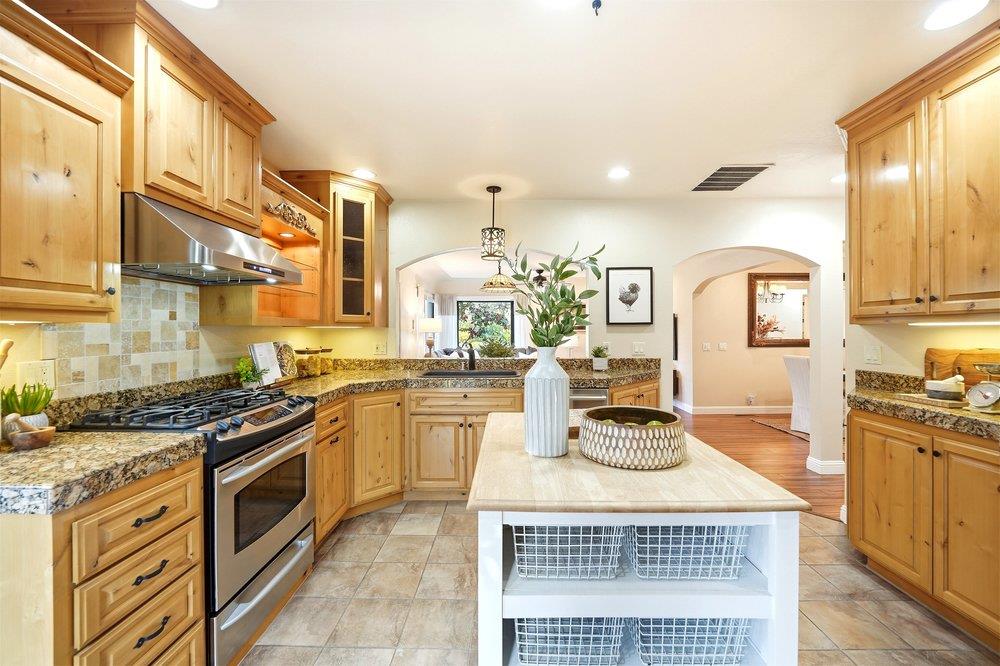 17235 Hill Road Morgan Hill, CA 95037 - Photo 7 of 44 a kitchen with stainless steel appliances granite countertop a stove a sink and a microwave