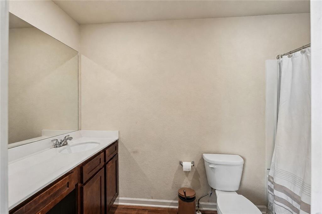 10933 Wheeler Trace Hampton, GA 30228 - Photo 15 of 22 a bathroom with a sink toilet and vanity