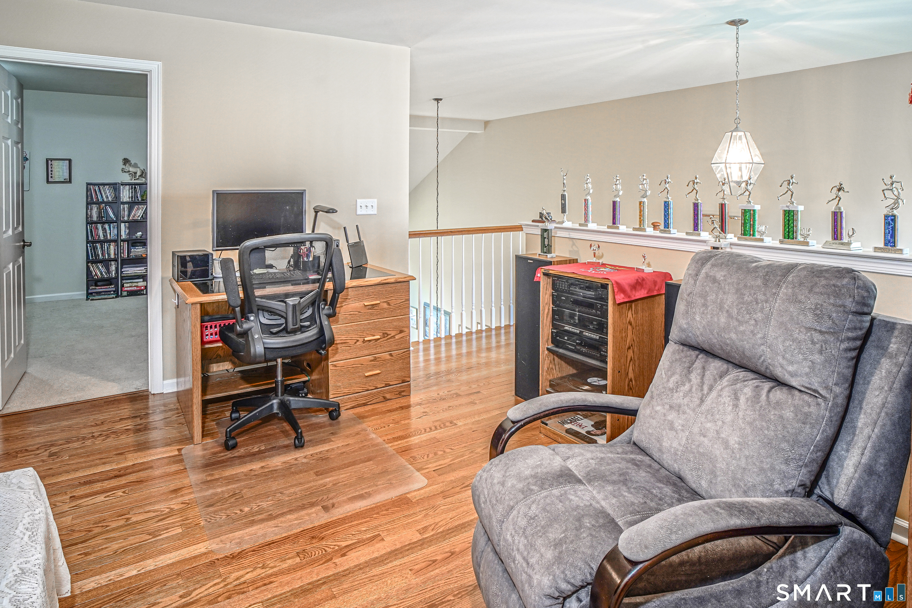 6 Lilac Lane, Unit 6 Prospect, CT 06712 - Photo 21 of 40 Upper-level family room with hardwood floors and views of the lower level.