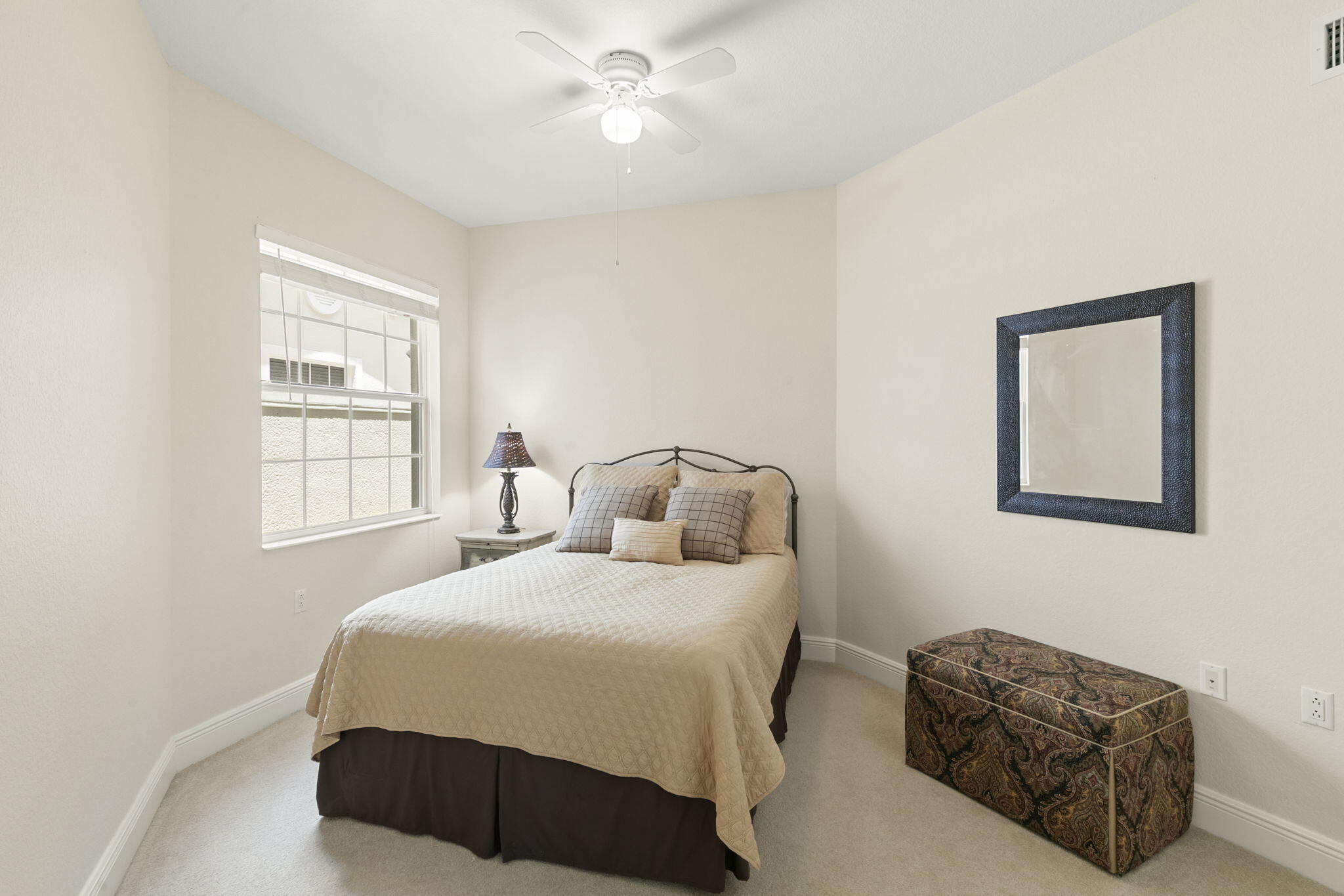 9066 Cascada Way, Unit 101 Naples, FL 34114 - Photo 22 of 51 a bedroom with a bed and a window