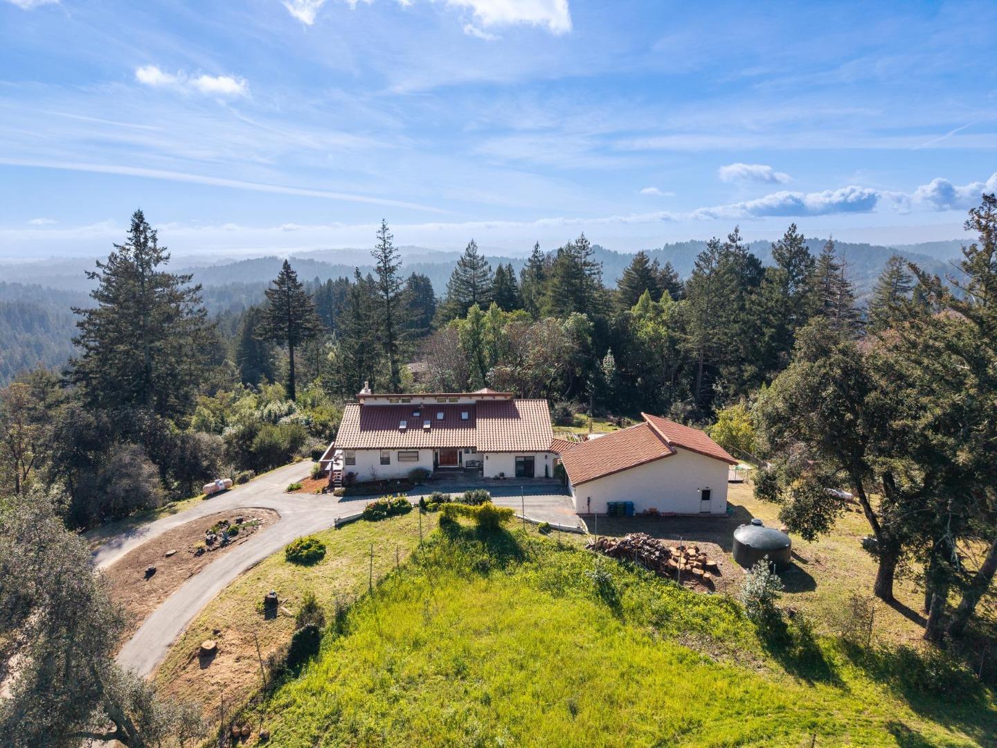 600 Ridge Top Road Los Gatos, CA 95033 - Photo 1 of 81 an aerial view of a house with swimming pool and mountains