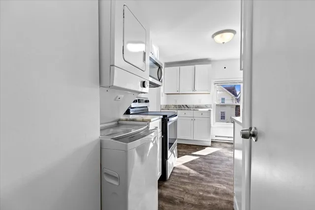 a kitchen with cabinets and a stove