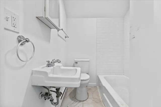 a bathroom with a sink toilet and tub