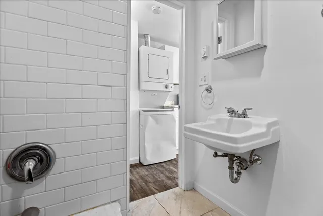 a bathroom with a sink a toilet a shower and a mirror