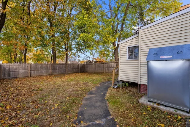 a view of a house with a backyard