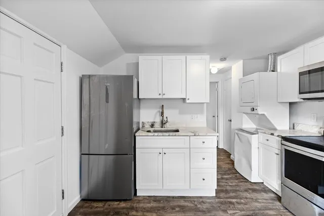 a kitchen with stainless steel appliances a refrigerator stove and sink