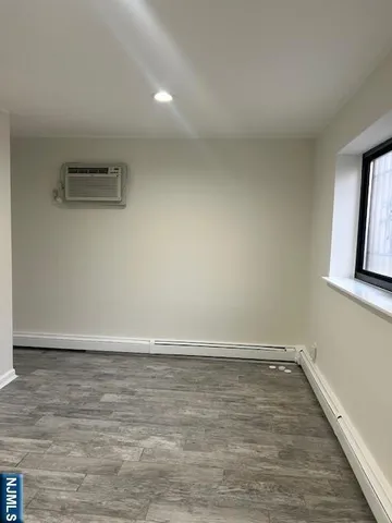 a view of a room with wooden floor and window